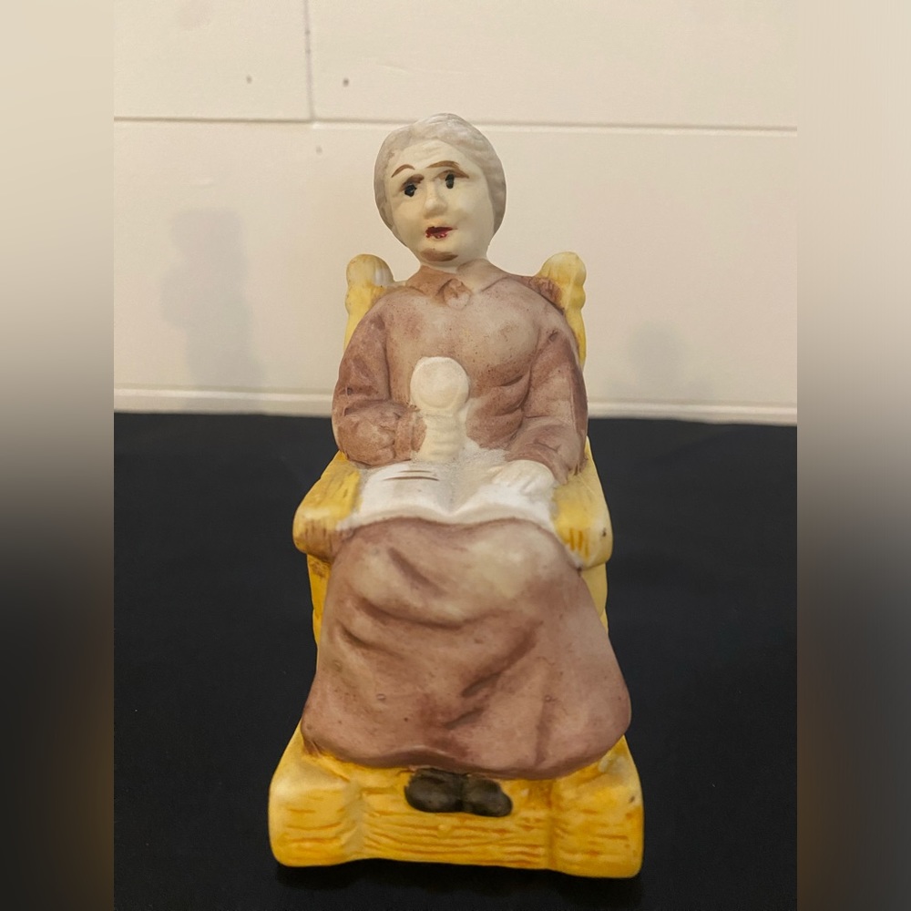 Vintage Figurine of Woman Sitting In Rocking Chair With Open Book Reading